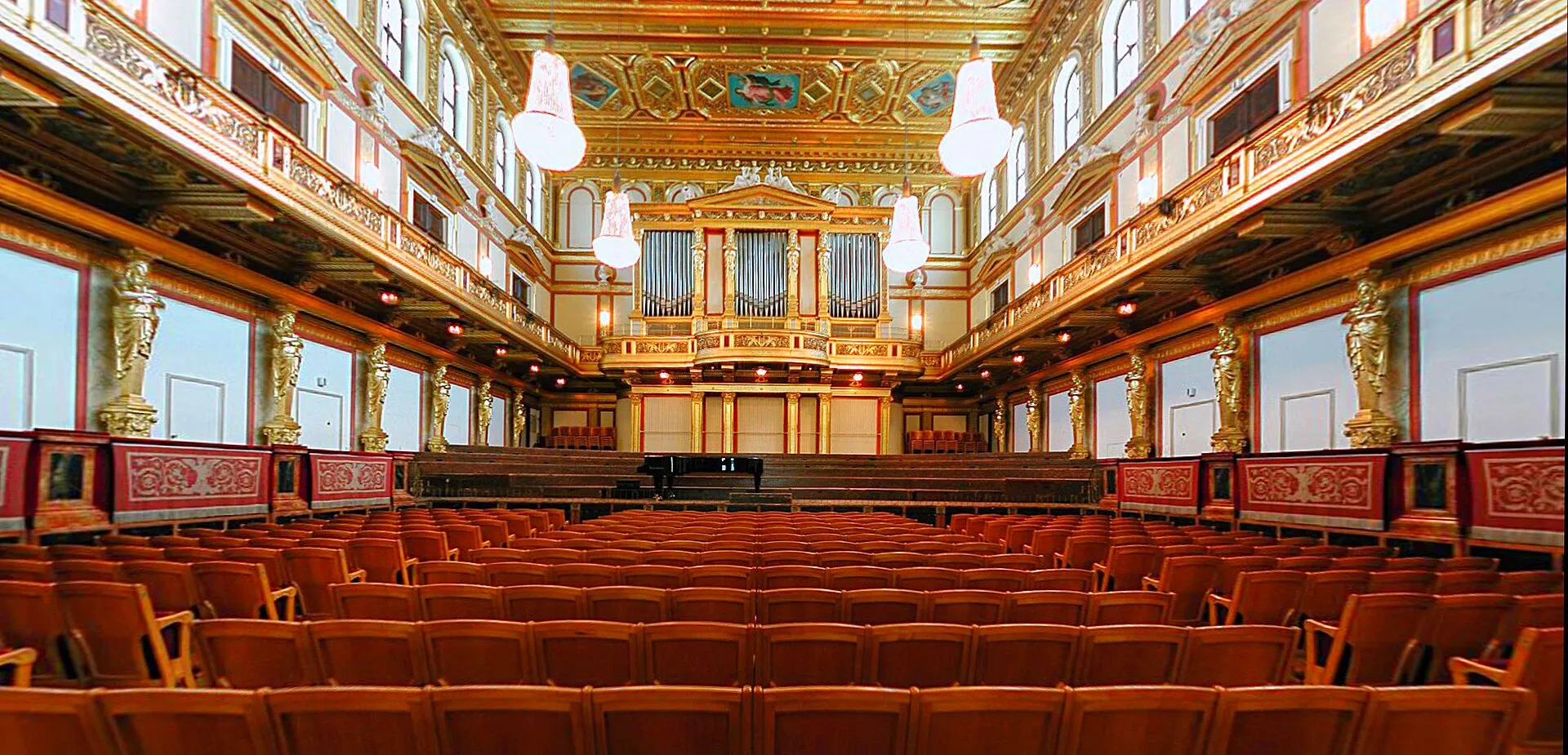 The Golden Hall of the Musikverein, gilded balconies and chandeliers lit for a concert