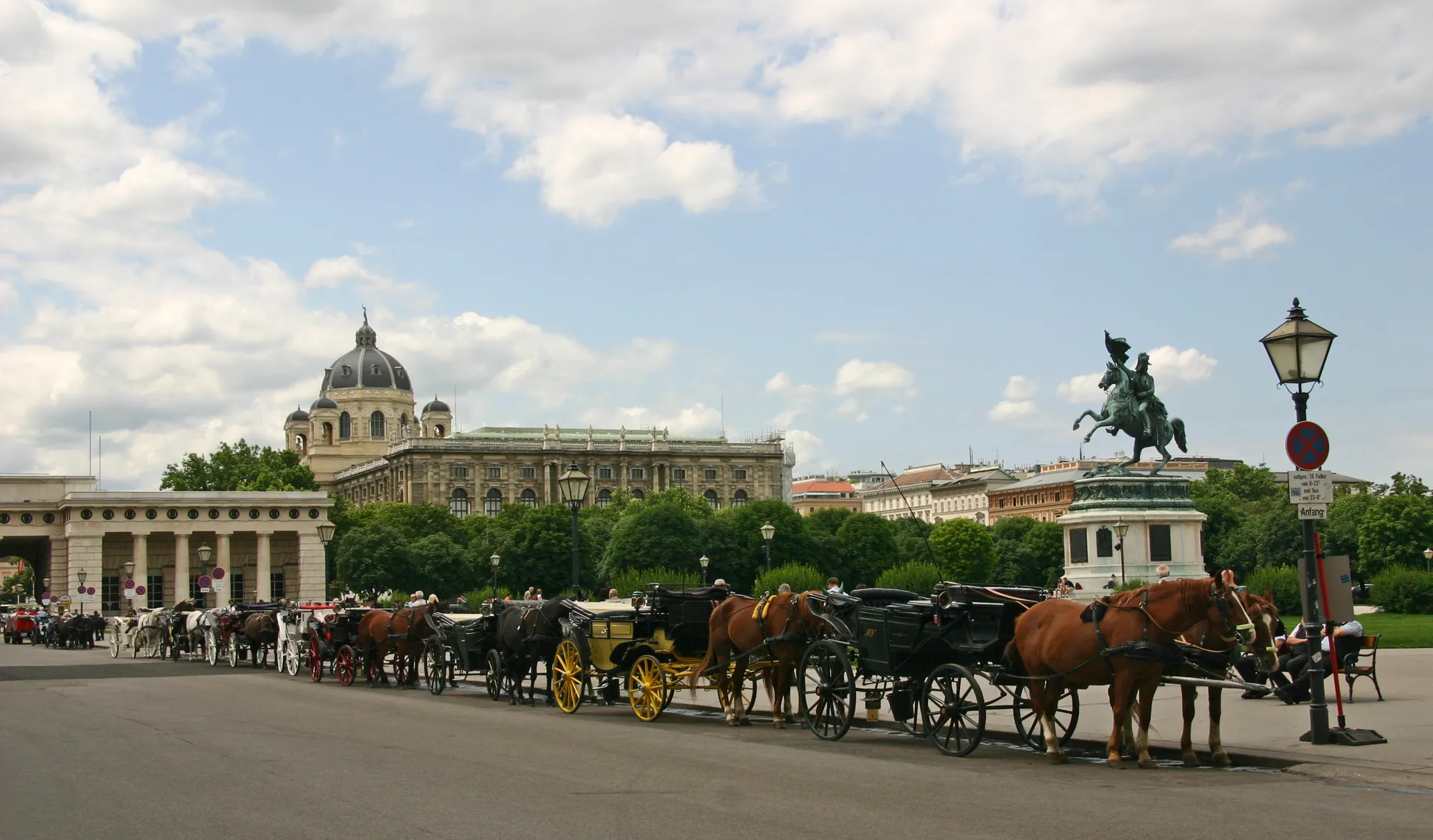 The Fiaker stand on Heldenplatz: a row of carriages waiting below the Archduke Charles monument, the museums behind.