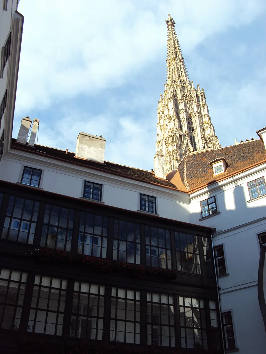 The courtyard of the Deutschordenshaus, the spire of St Stephen’s cathedral rising directly behind its roof.