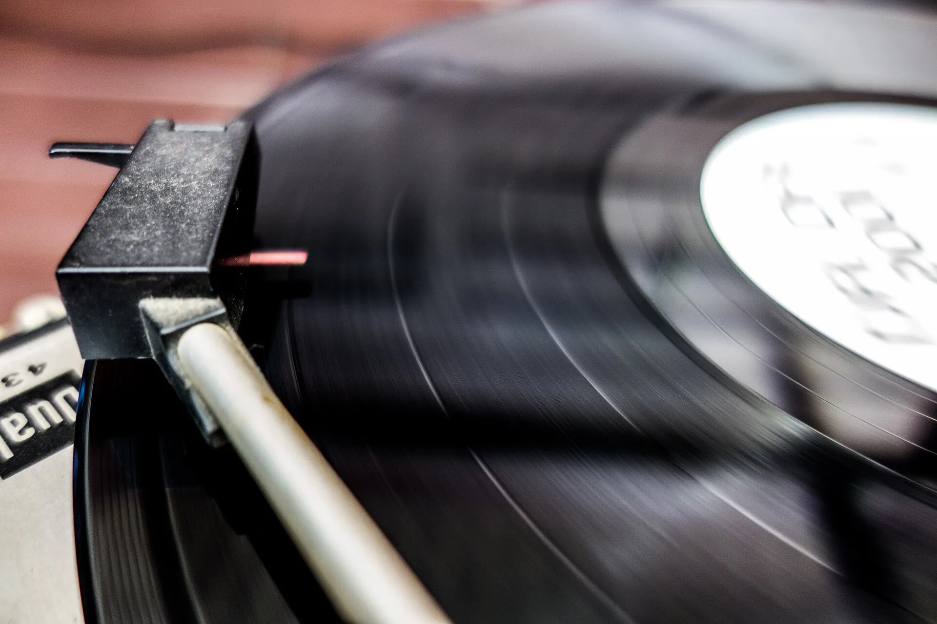 A vinyl LP turning on a turntable, the stylus in the groove