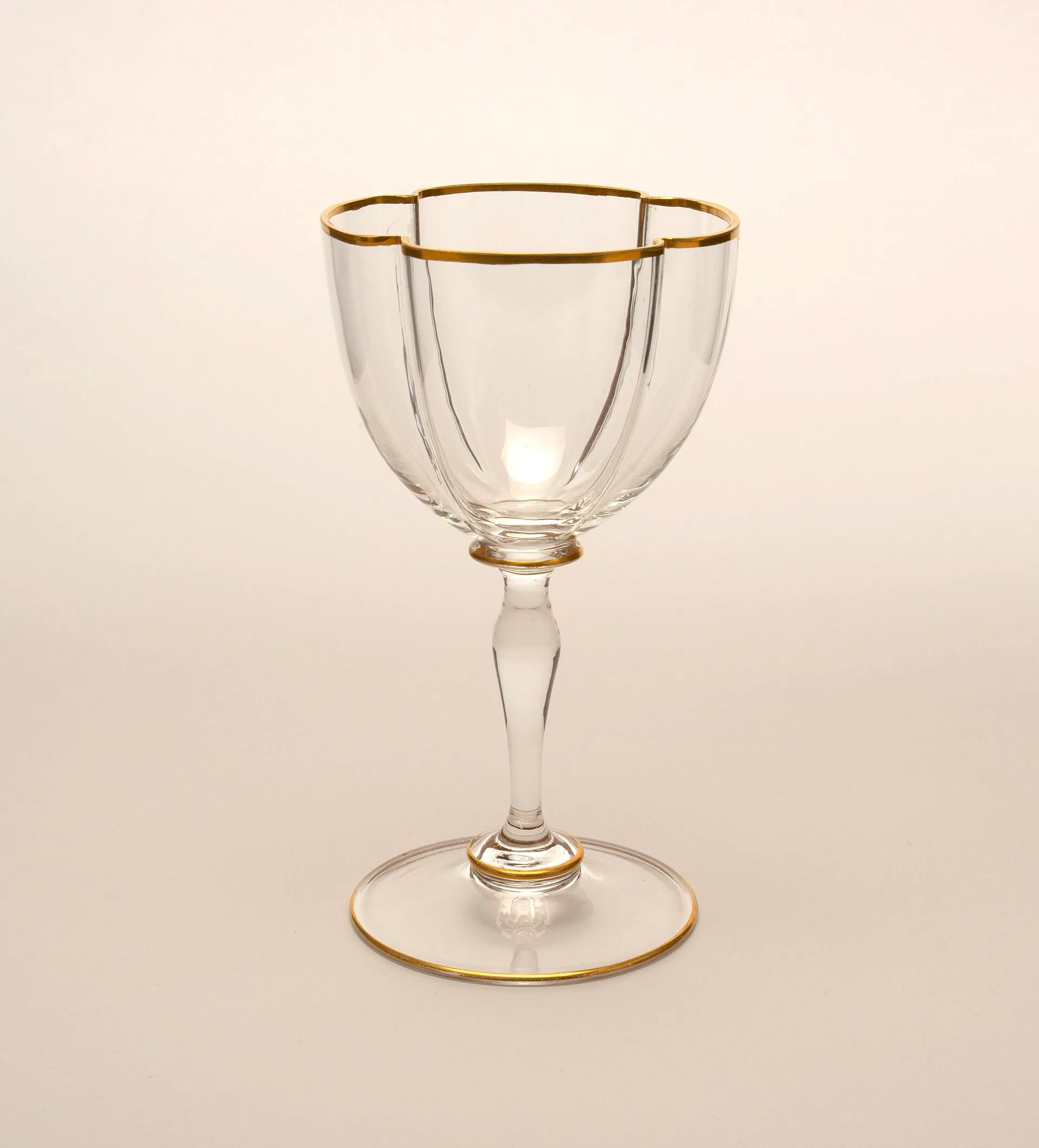 A tall mouth-blown white wine glass with a fine gilded rim, Vienna, c. 1870