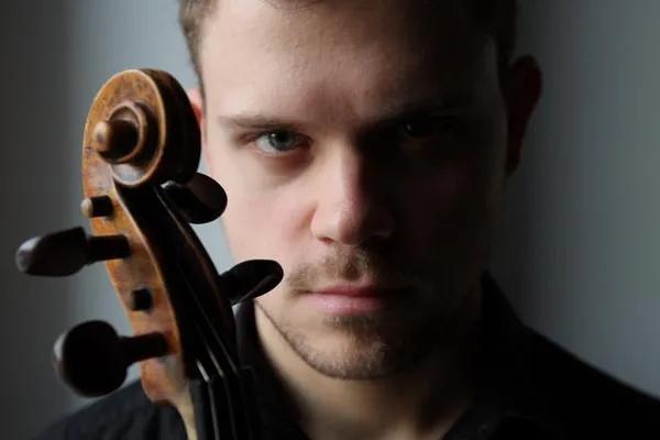 Dimitris Karakantas, concertmaster of Orchester 1756, behind the scroll of his violin.