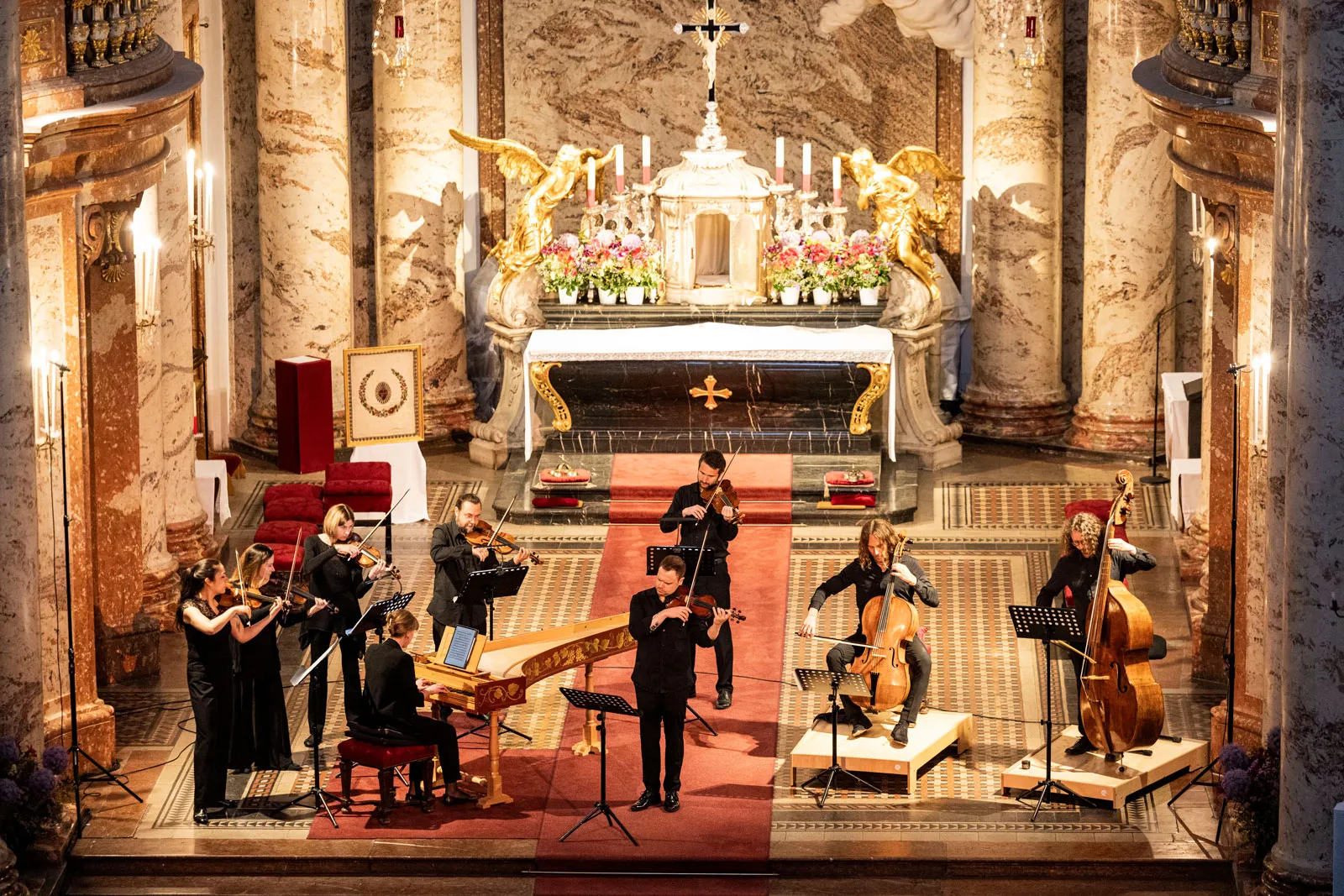 The nave of the Karlskirche set for a concert: the ensemble and their harpsichord before the high altar.