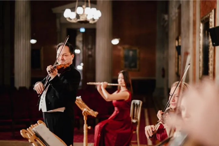 Arpad Patkolo playing first violin with the ensemble.