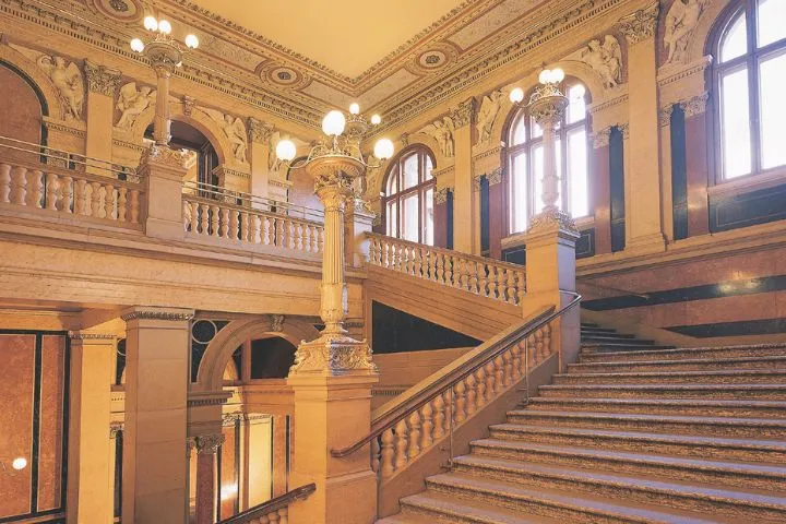 The staircase up to the concert hall of the Palais alte Börse, its stone balustrades and globe lamps.